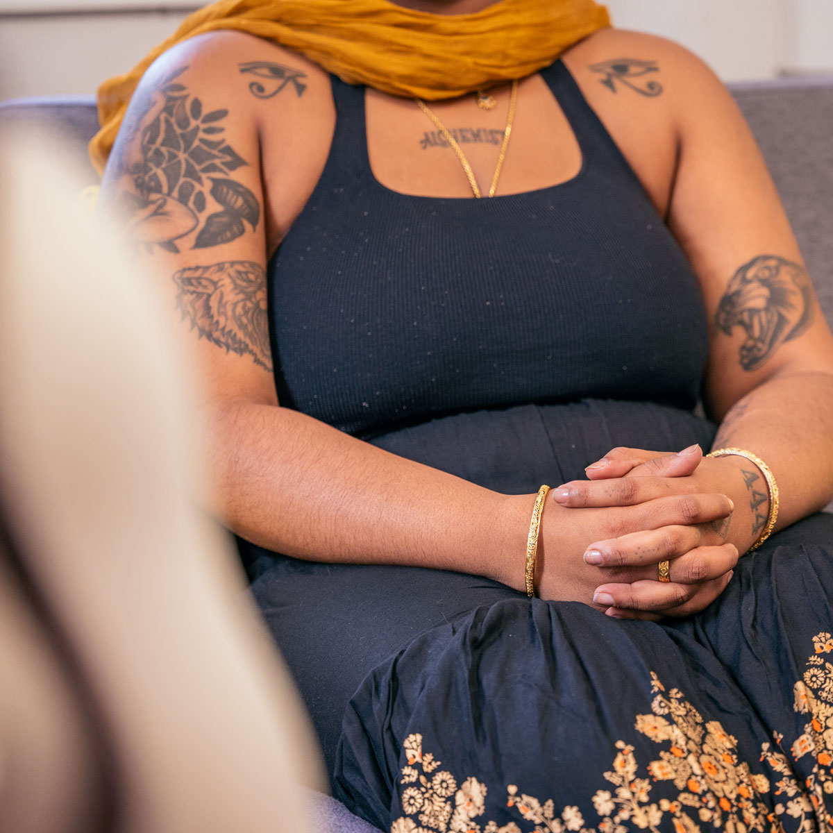 Photo of a person sitting on a couch at a counselling session